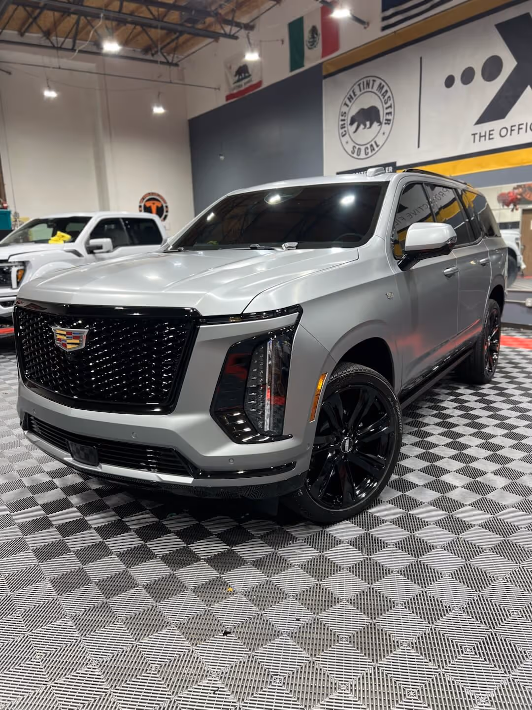 Silver Cadillac Escalade inside Tint Masters during paint protection film service