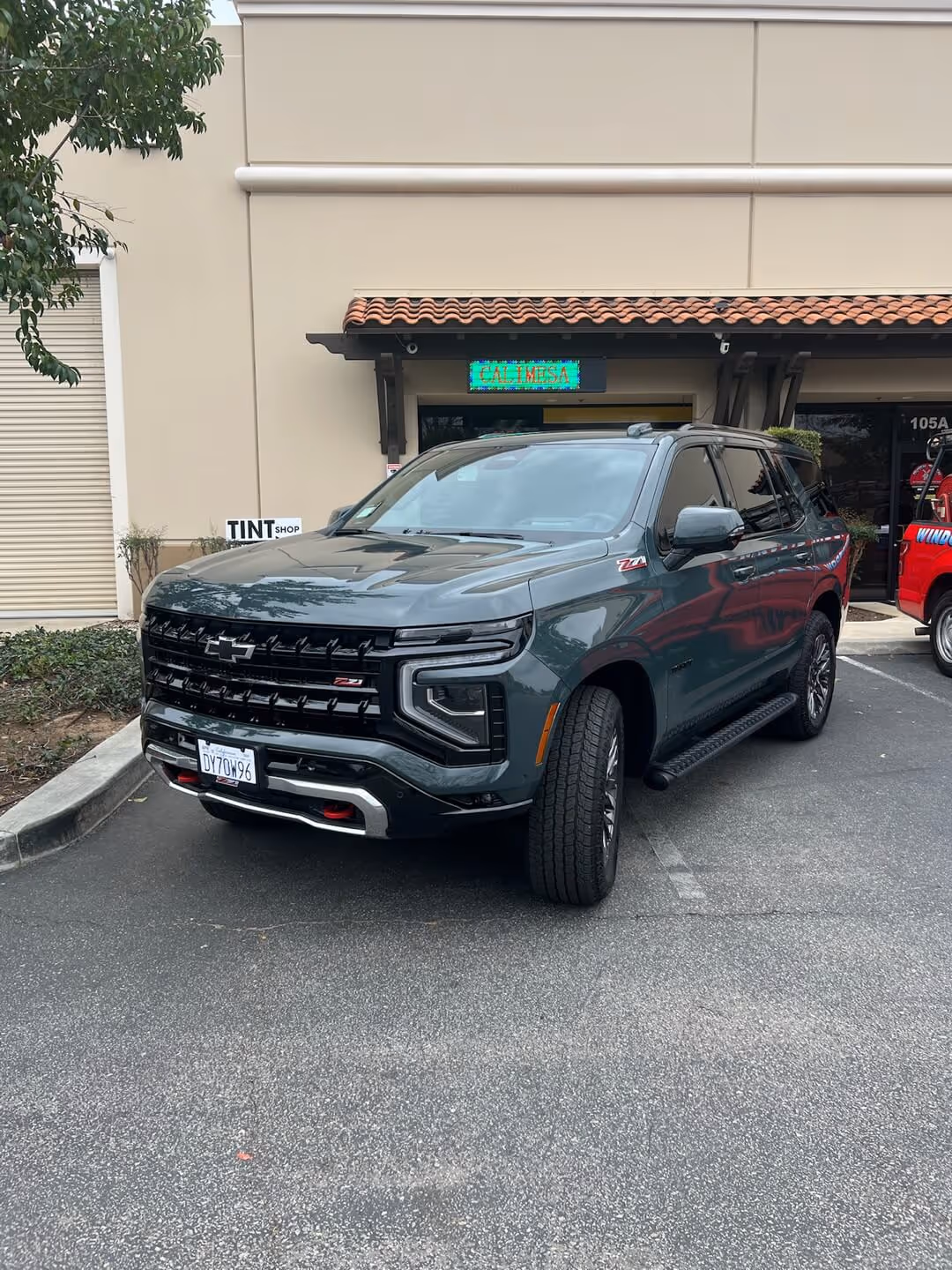 Black Chevrolet Silverado with glossy ceramic coating parked outside Tint Masters