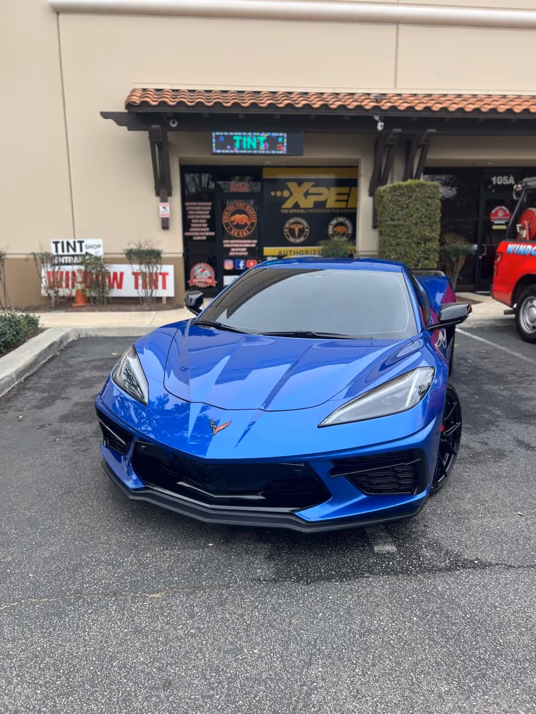Blue Chevrolet Corvette C8 parked outside Tint Masters for paint protection film installation