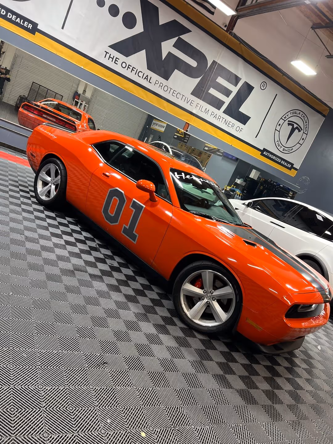 Orange Dodge Challenger General Lee tribute car inside Tint Masters installation bay